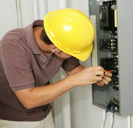 residential electrician working on service panel