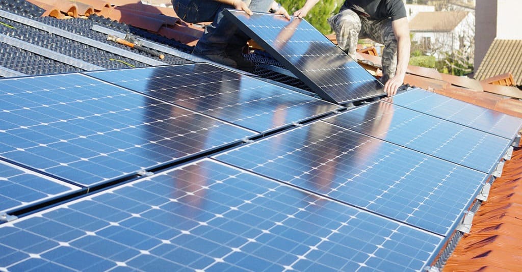 solar panels being installed on roof of home
